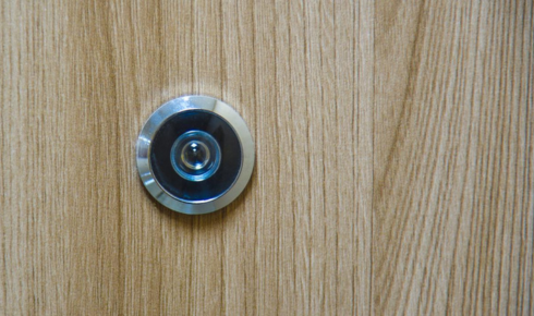 How can adding a simple peephole or camera at the door improve safety