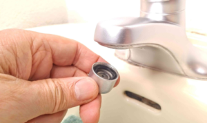 How can fitting aerators on taps reduce both water use and splashing