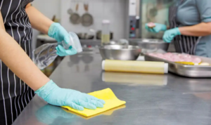 How can keeping separate cloths for kitchen and bathroom prevent cross-contamination