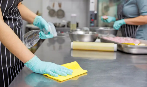 How can keeping separate cloths for kitchen and bathroom prevent cross-contamination