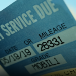 How can noting the date of each service on a small sticker help with future maintenance