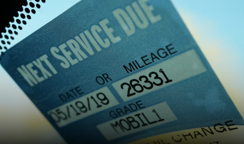 How can noting the date of each service on a small sticker help with future maintenance