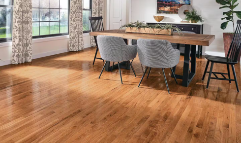 How can planning where heavy furniture will go affect which flooring material you pick