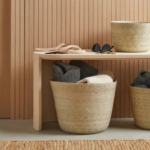 How can using baskets in open storage keep things practical but still visually tidy