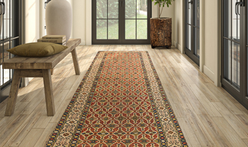 How can using runners in long corridors protect the main flooring underneath