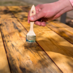 How can using stain-resistant paint in busy areas save you effort later