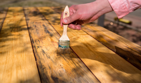 How can using stain-resistant paint in busy areas save you effort later