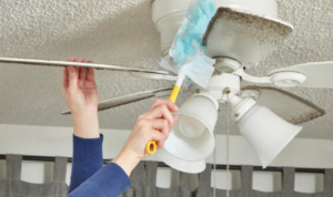 How does cleaning fan blades regularly affect comfort in hot weather