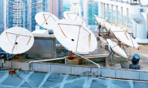 Why is it important to check that satellite dishes or antennas are firmly fixed to the roof